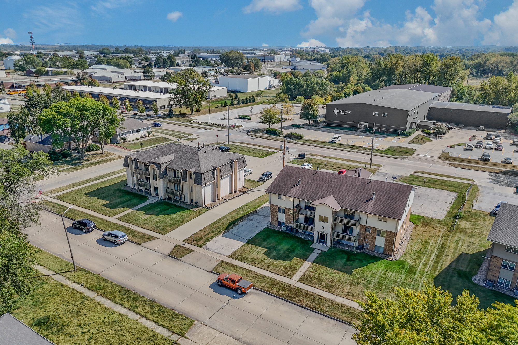 Aerial view of Belmont Manor, two three-story apartment buildings with private balconies on wide lawns along SE Belmont Drive in Ankeny, Iowa, with southeast Ankeny stretching out beyond them.